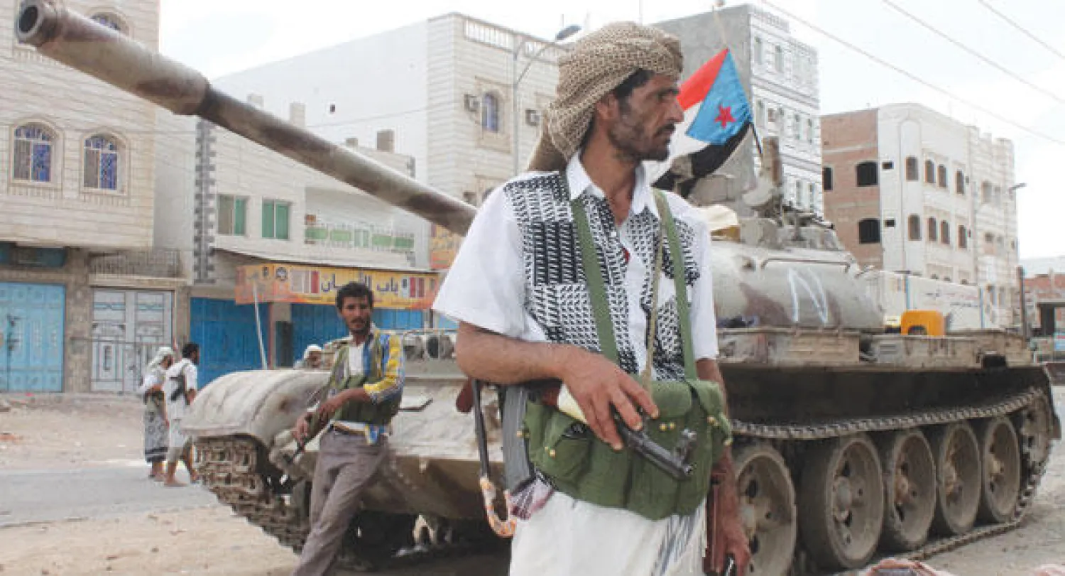 يمنيون من الحراك الجنوبي أمام دبابة في حالة تأهب لمواجهة الحوثيين أمس (أ.ف.ب)