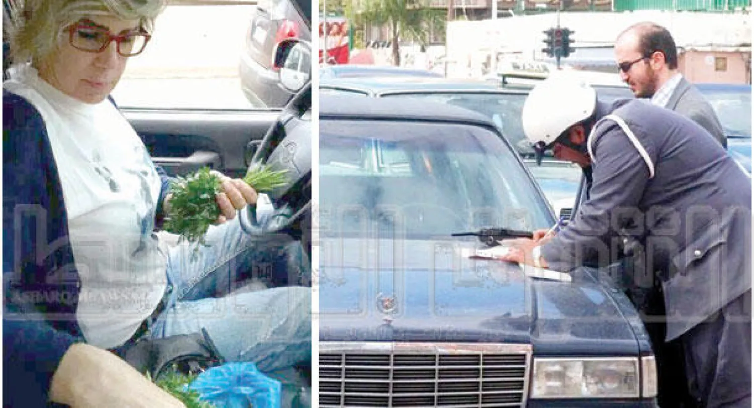 شرطي سير يحرر مخالفة مرورية لأحد السائقين ({الشرق الأوسط})، سائقة ترتب مشترياتها أثناء القيادة