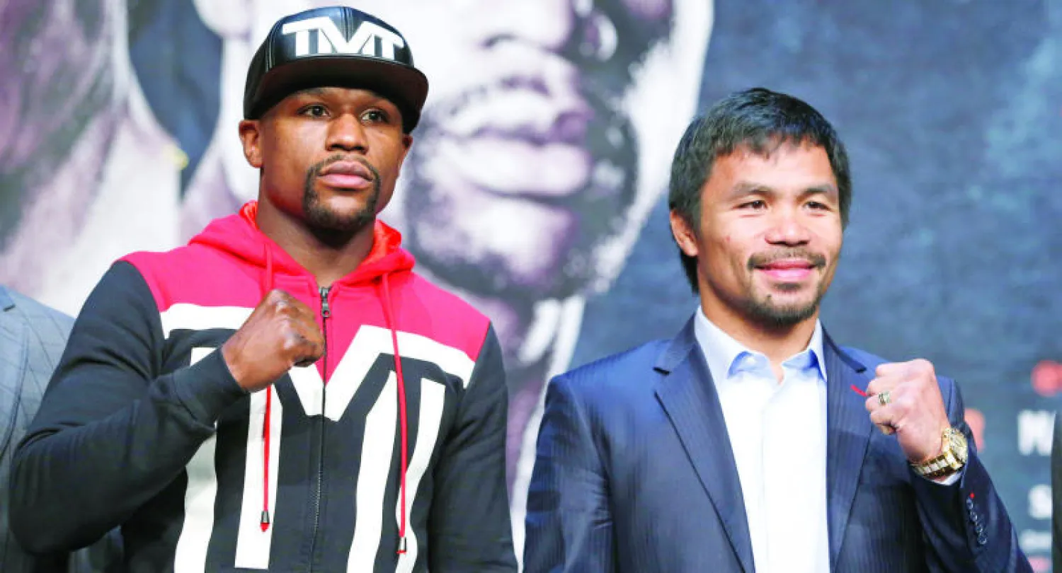 العالم ينتظر مباراة القرن بين ماني باكياو ومايويذر جونيور (أ.ب)