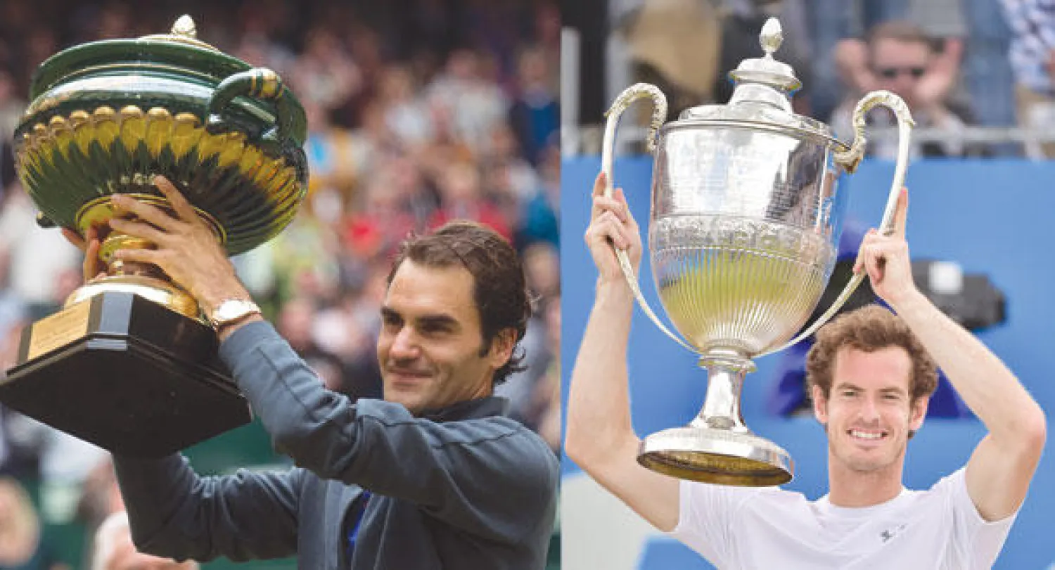 موراي وكأس دورة كوينز (اأ.ف.ب)  -  فيدرر يحتفل بكأس بطولة هاله (إ.ب.أ)