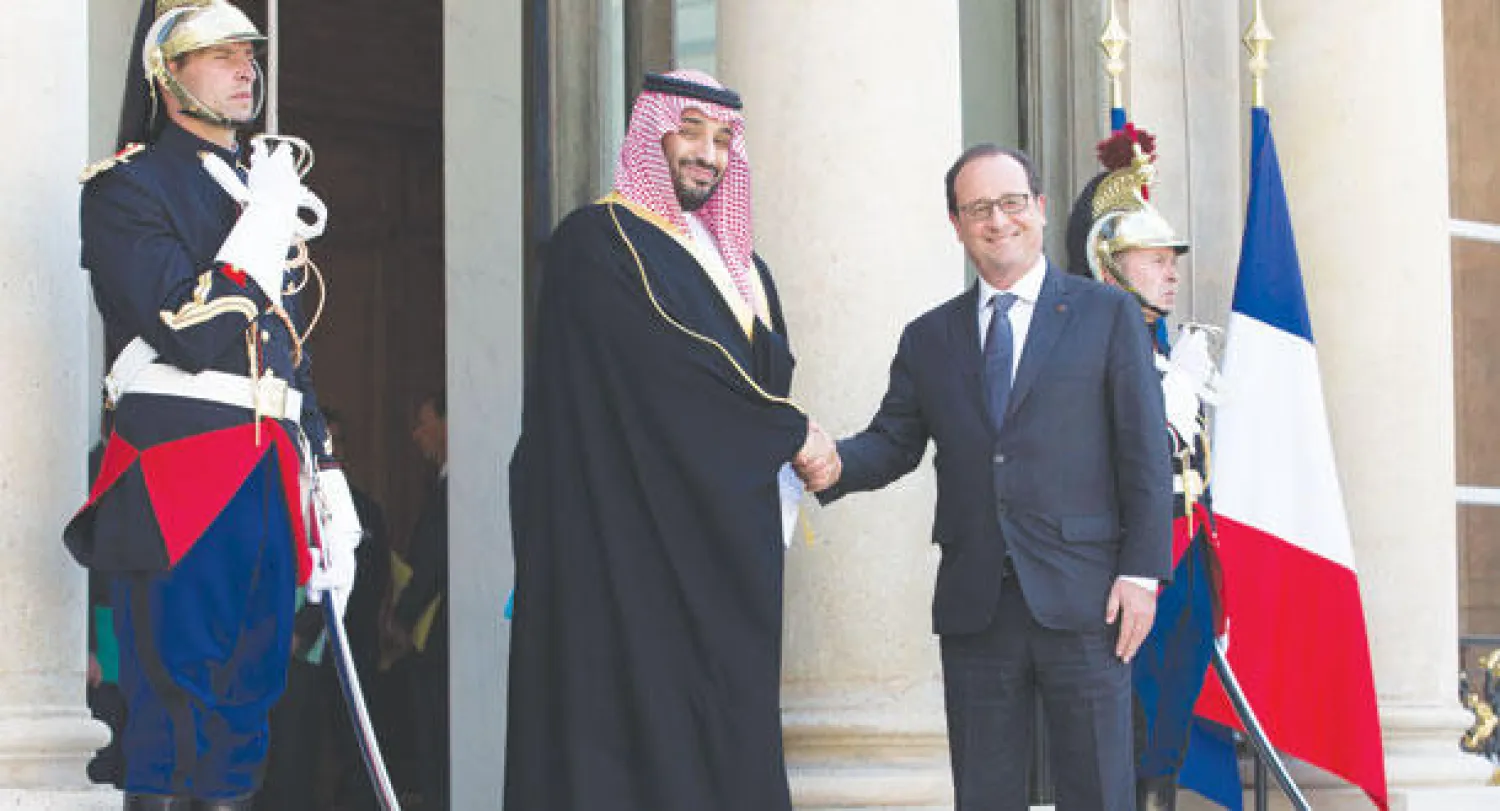 الرئيس الفرنسي لدى استقباله ولي ولي العهد السعودي في قصر الإليزيه بباريس أمس (إ.ب.أ)