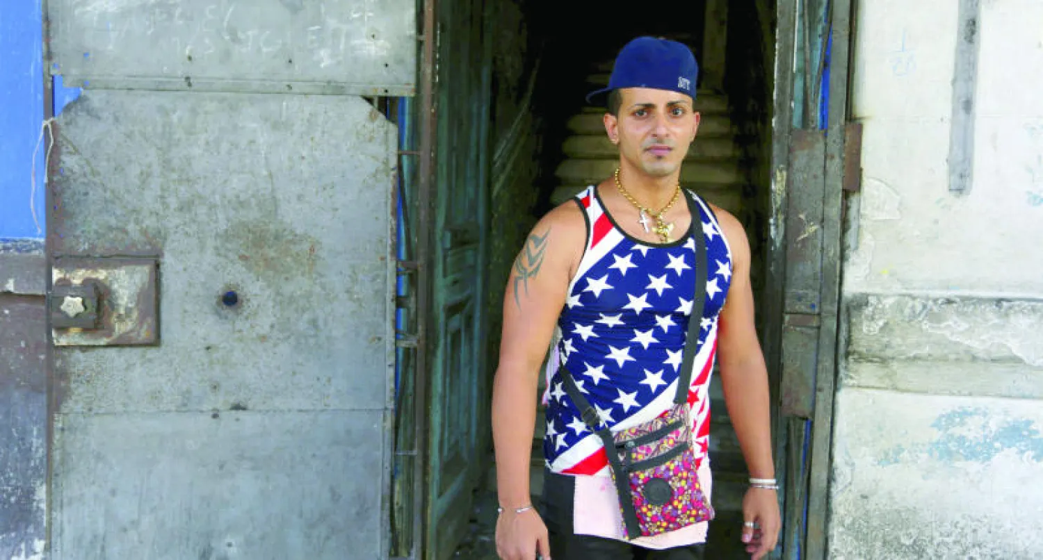 شاب كوبي يرتدي قميصا عليه العلم الأميركي في هافانا أمس (رويترز)