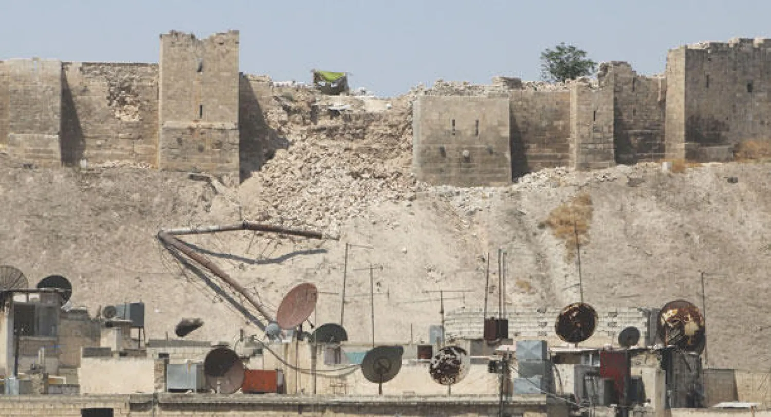 قلعة حلب وقد دُمِّر جزء من سورها على أثر تفجير قوات النظام لأحد الأنفاق أمس وفي الإطار صورة قريبة للدمار (رويترز)