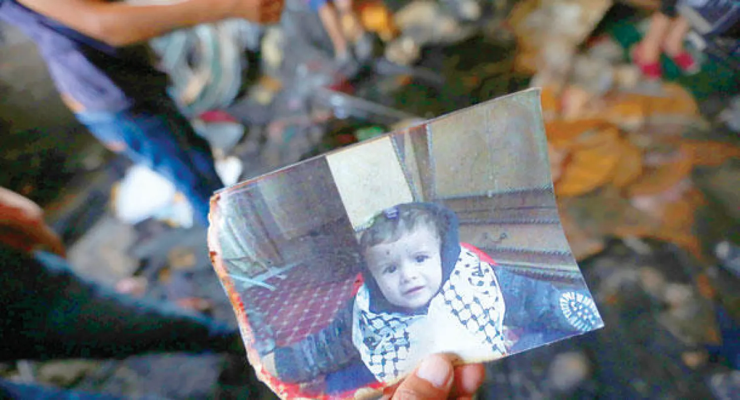 صورة الطفل علي دوابشة الذي أحرقه مستوطنون في منزله أمس بنابلس في الضفة الغربية (إ.ب.أ)