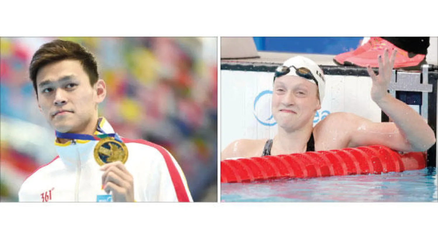 الأميركية ليديكي تعرب عن سعادتها بالرقم القياسي لسباق 1500 متر حرة (أ.ب)، الصيني يانغ سون فاز بذهبية 400 متر ويتطلع لأخرى في 200 متر (أ.ف.ب)