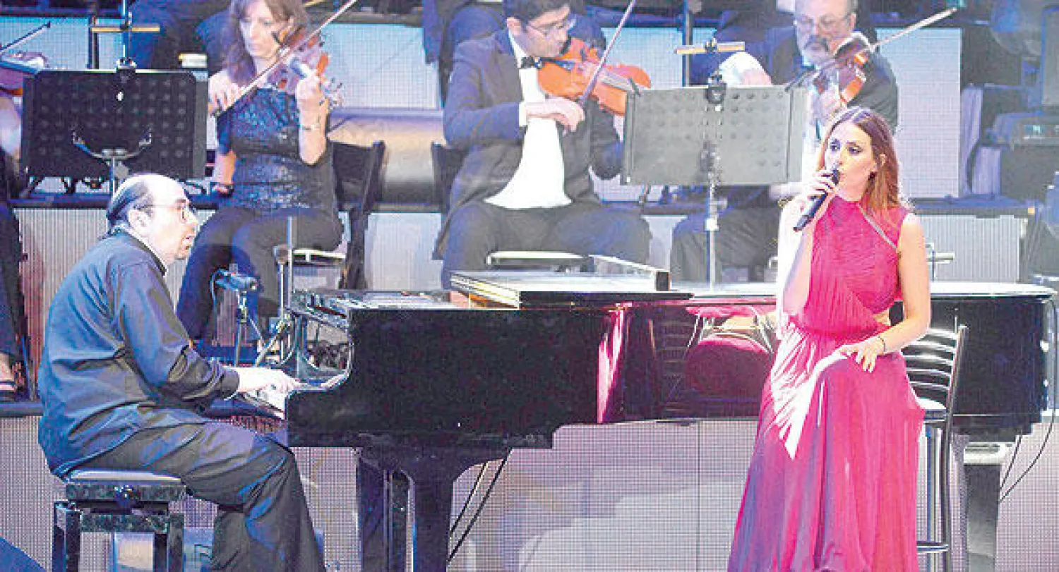 هبة طوجي مع عازف البيانو أسامة علي أثناء العرض الغنائي ({الشرق الأوسط})