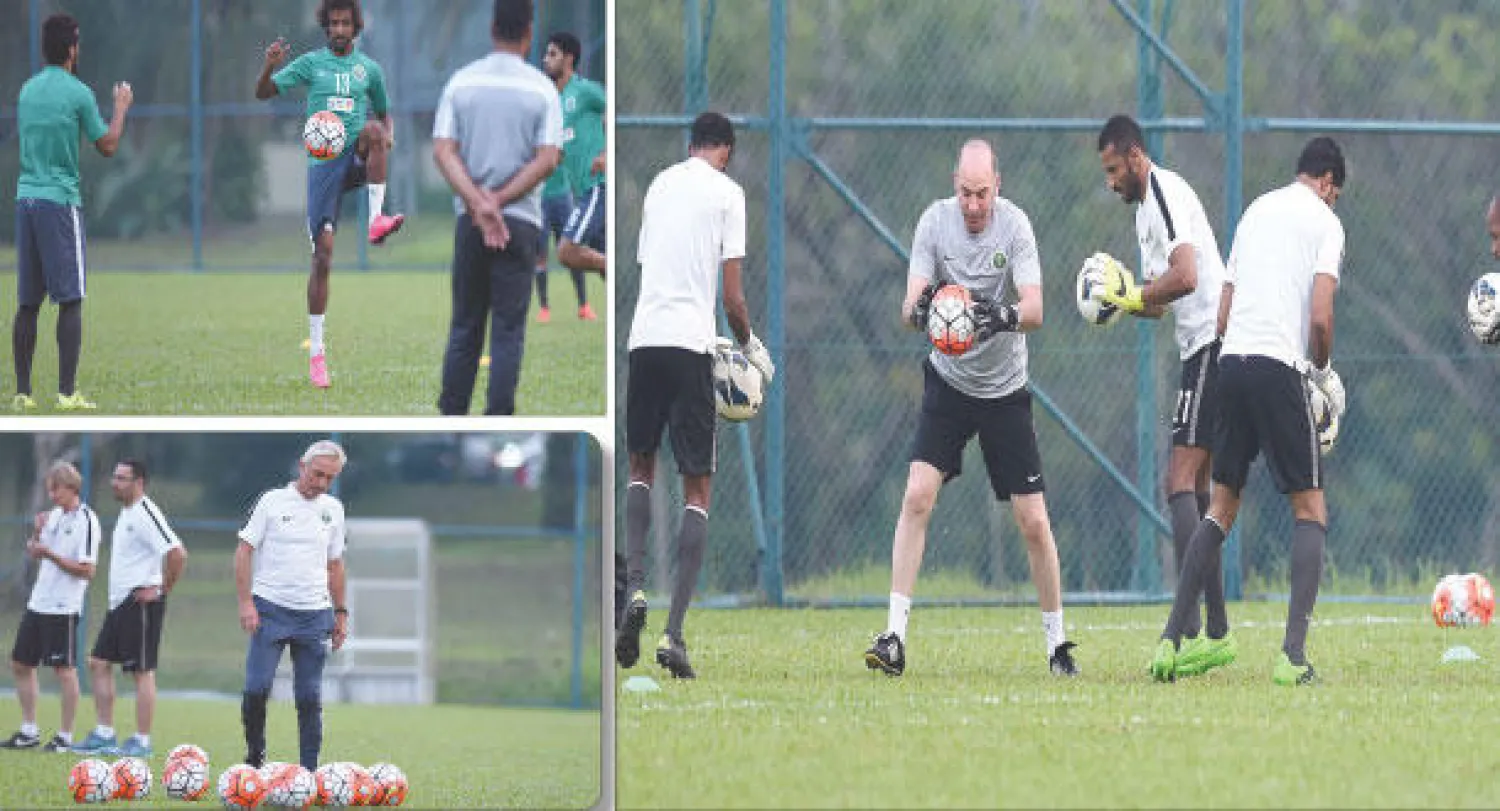 جانب من تدريبات المنتخب السعودي أمس في ماليزيا.. ويبدو ياسر الشهراني وعبد الفتاح عسيري يتبادلان الكرة ، و فان مارفيك مدرب الأخضر خلال الحصة التدريبية أمس (المركز الإعلامي للمنتخب السعودي)