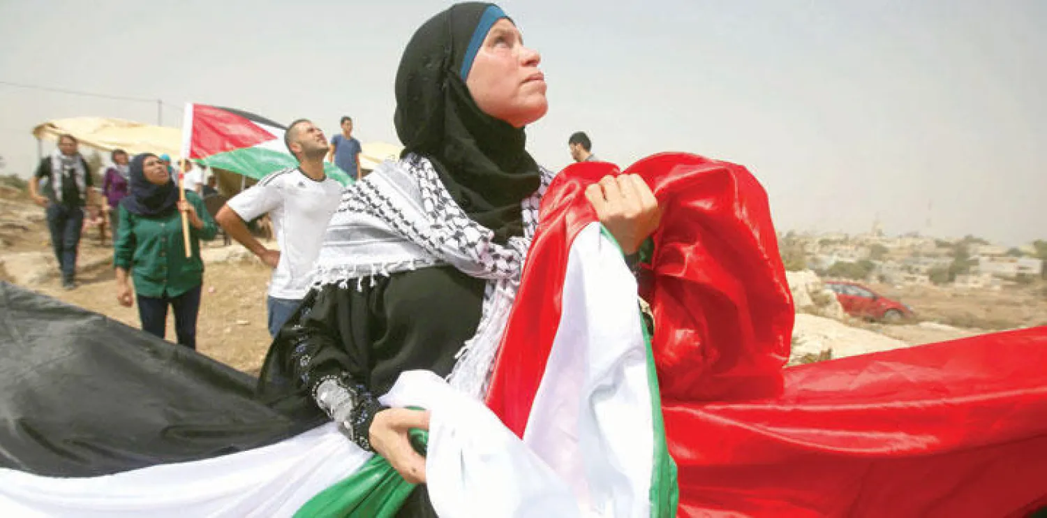 احتفالات فلسطينية بقرار رفع العلم في الأمم المتحدة جرت في رام الله أمس (أ.ف.ب)