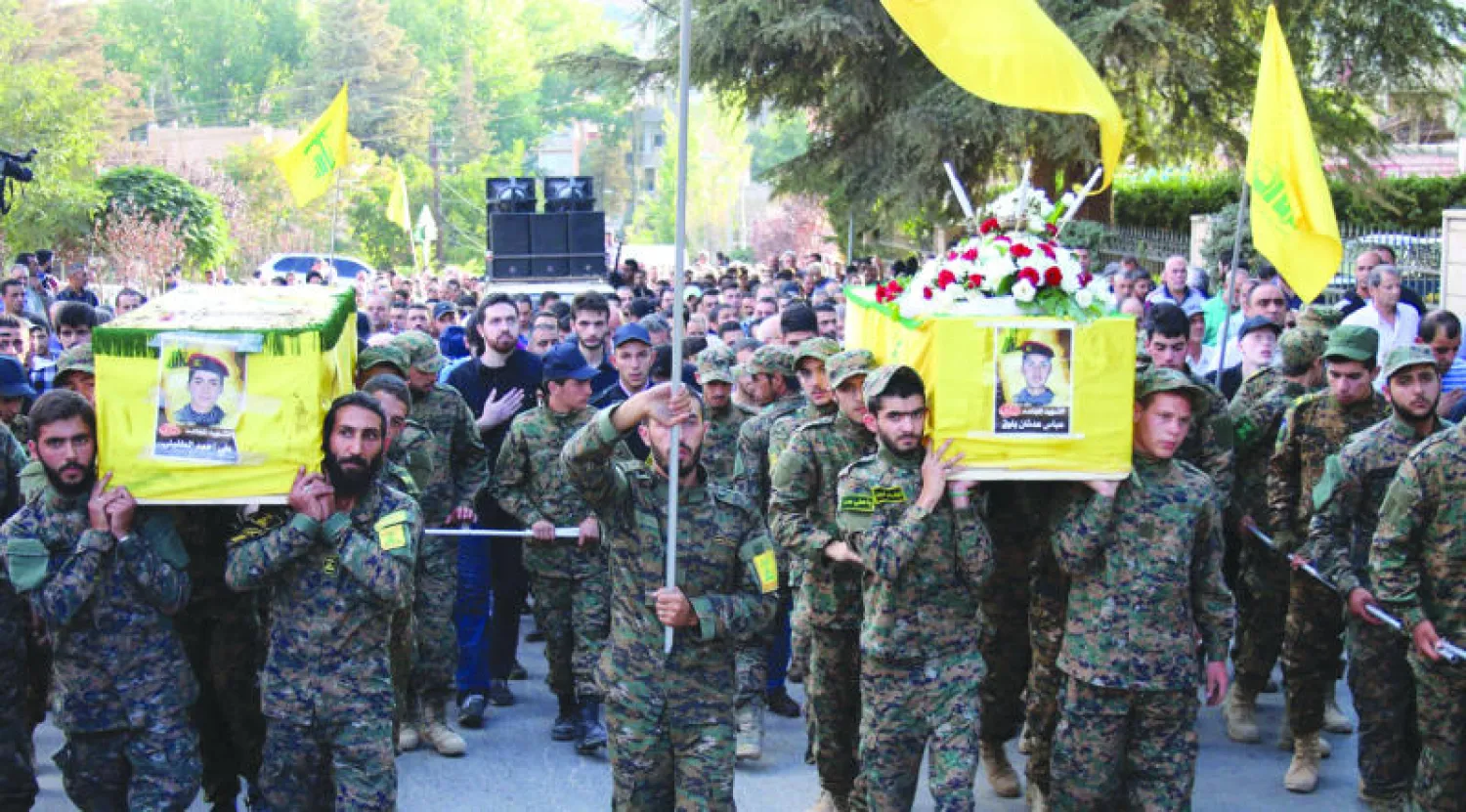 مقاتلون تابعون لحزب الله في بعلبك شرق لبنان يحملون جثامين رفاق لهم قتلوا في معارك بسوريا (أ.ف.ب)