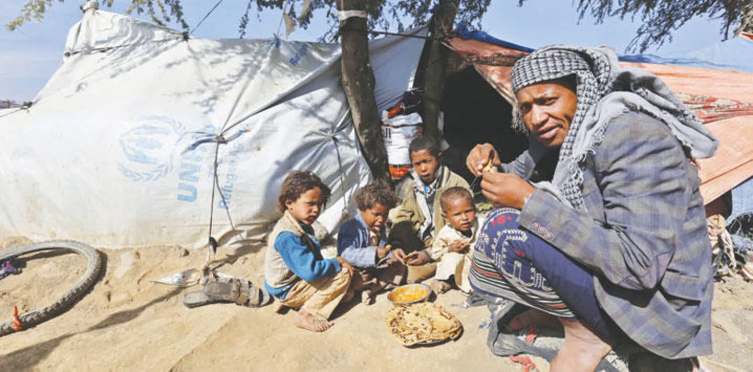 لاجئ يمني فر من المعارك الدائرة ليستقر مع أولاده في خيمة بالقرب من مدينة عمران (إ ب أ)