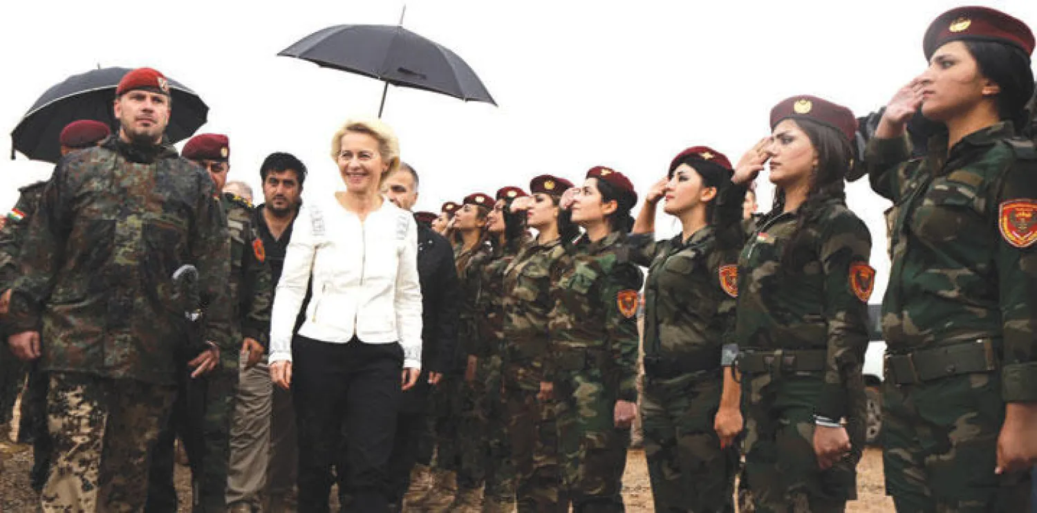 وزيرة الدفاع الألمانية تمر أمام فوج من مجندات البيشمركة بأربيل أمس (أ.ف.ب)