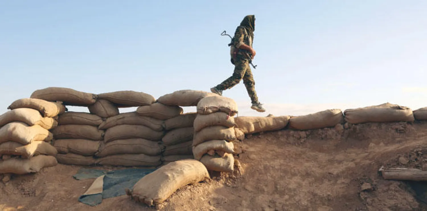 مقاتل من القوات السورية الديمقراطية التي تضم أكرادا وعرب وآشوريين يراقب منطقة ريف الحسكة أمس بعد أول مواجهة بين القوات وتنظيم داعش (أ.ف.ب)