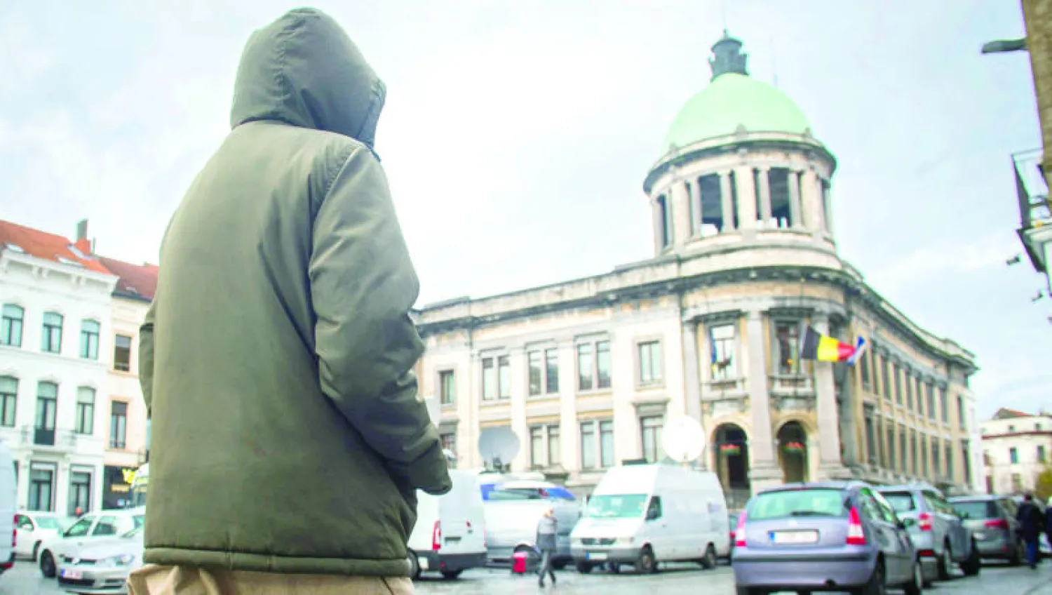 رجل يسير في ميدان حي مولنبيك إلى الشرق من بروكسل وهو الحي البلجيكي الذي يعتقد أنه مقر للعديد من المتطرفين (إ.ب.أ)