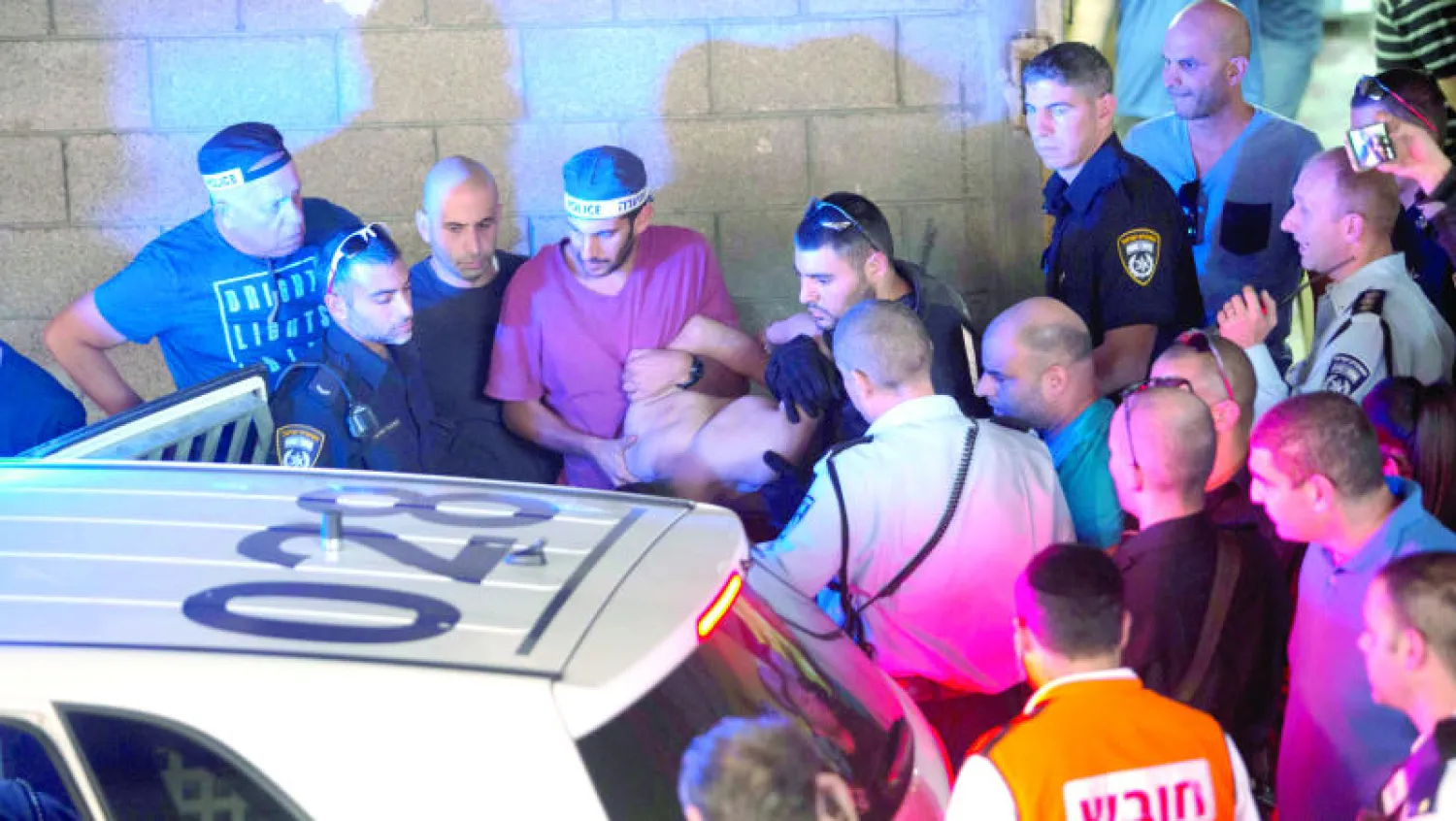عناصر من الشرطة الإسرائيلية أثناء اعتقالهم الفلسطيني رائد خليل محمود بعد طعنه إسرائيليين في تل أبيب (أ.ب)
