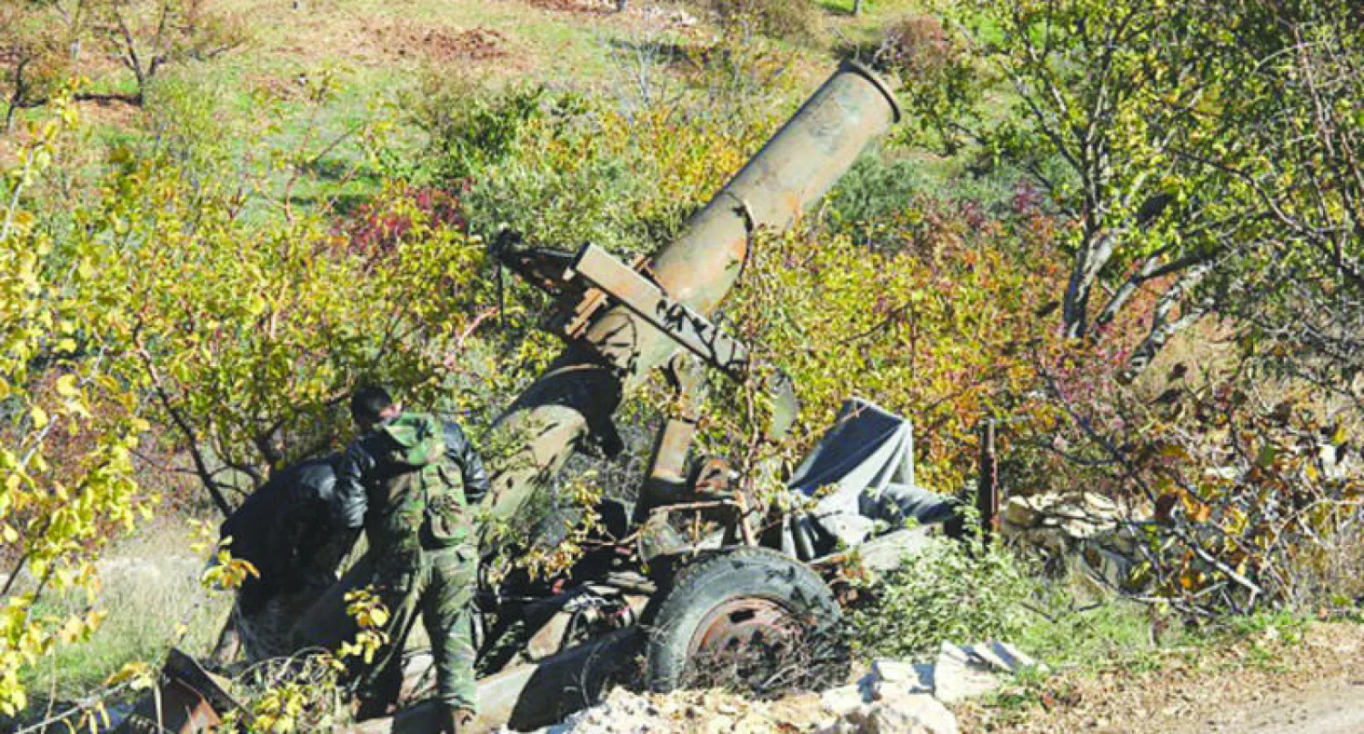 عناصر من «جيش الفتح» المعارض يجهزون لإطلاق قذيفة على قوات النظام في ريف اللاذقية (غيتي)