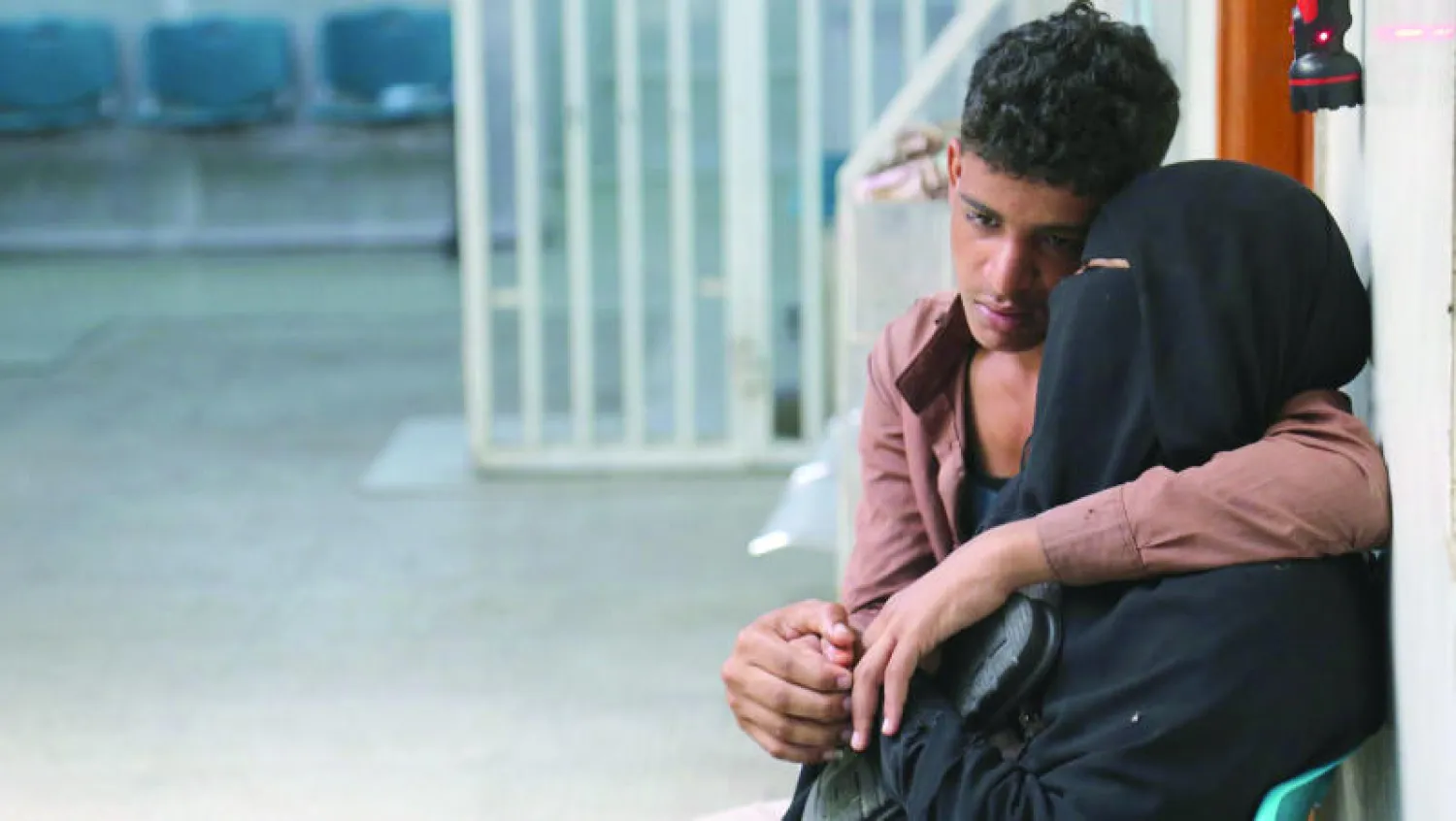 يمني يولسي أمه بعد مقتل شقيقه في اشتباكات بمدينة تعز بين قوات المقاومة وميليشيا الحوثي (أ.ف.ب)