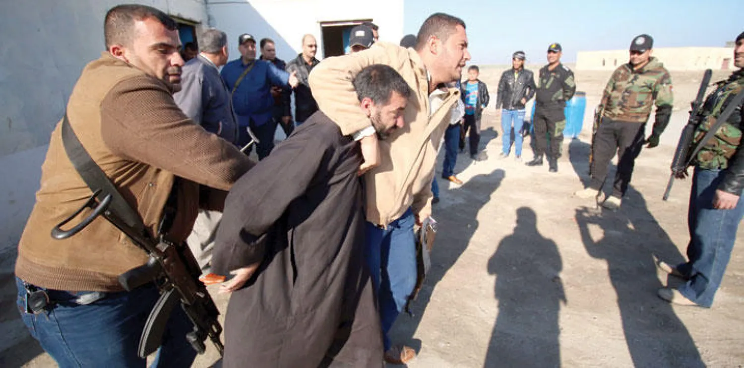 قوات أمن عراقية تعتقل مشتبها به في منطقة نهر عز شمال البصرة خلال عملية تقوم بها في محاولة لاحتواء تفشي الجريمة والعصابات وتردي الوضع الامني في البصرة (أ.ف.ب)