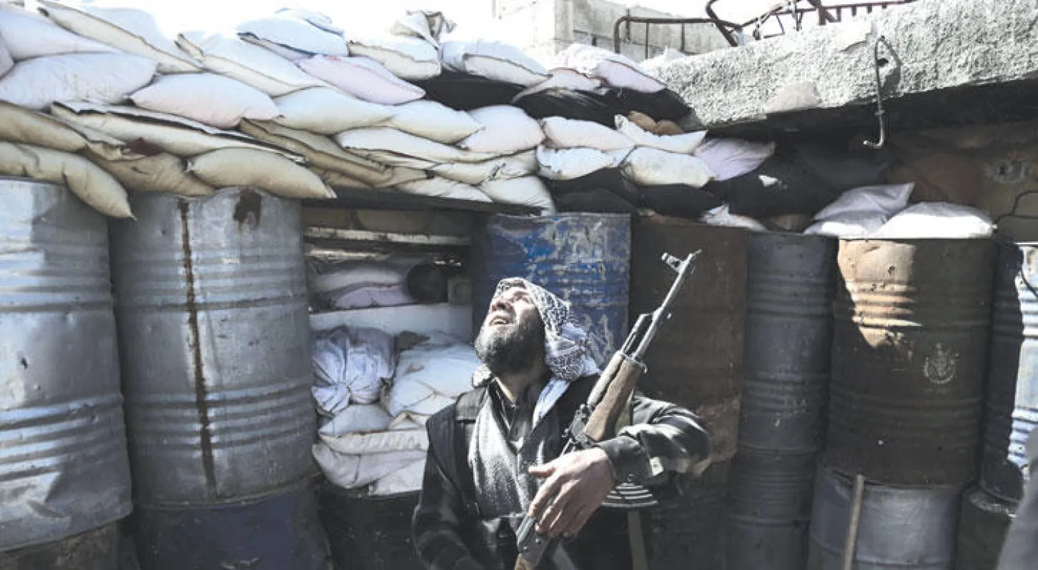 مقاتل معارض من {فيلق الرحمن} في أحد المواقع القتالية ضد قوات النظام في عربين إحدى قرى ريف دمشق (أ.ف.ب)