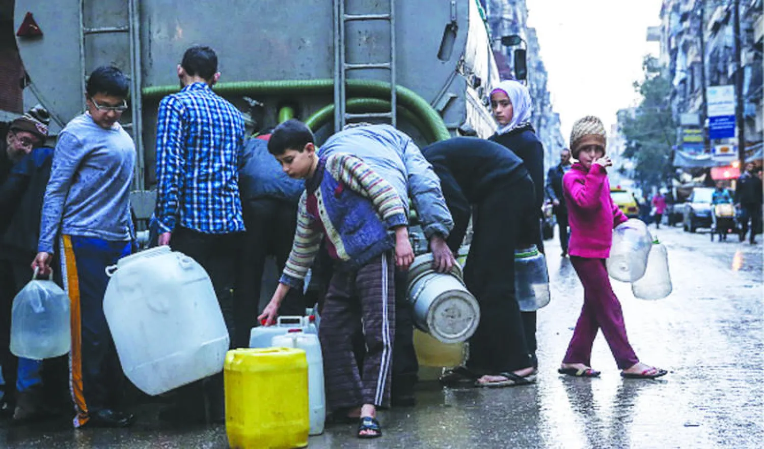 أطفال سوريون يتزودون بالمياه في حي صلاح الدين بحلب («غيتي»)