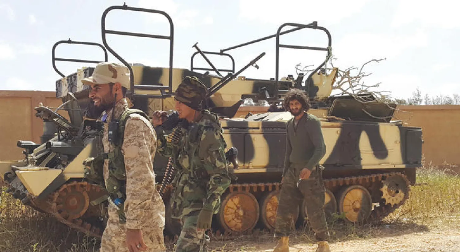 جنود ليبيون بجانب مدرعة بعد الانتهاء من الاشتباكات مع الميليشيات المتطرفة (رويترز)