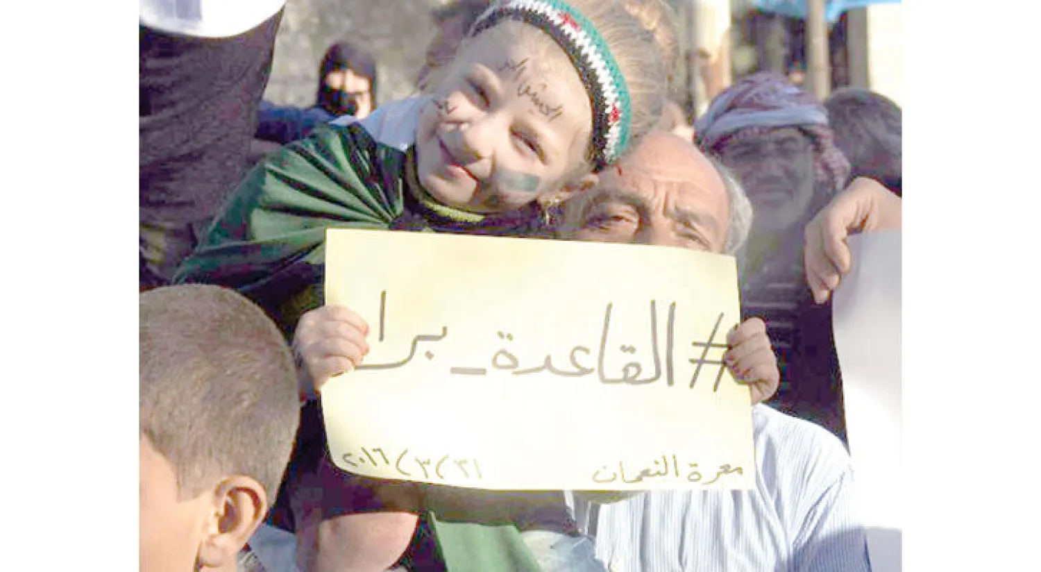 «(القاعدة) برا».. لافتة رفعها متظاهرون أمس في معرة النعمان بريف إدلب ضد ممارسات «جبهة النصرة» (وسائل التواصل الاجتماعي)