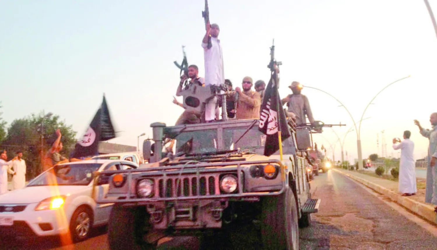 عناصر من داعش بأسلحتهم في مدينة الموصل العراقية (أ.ب)