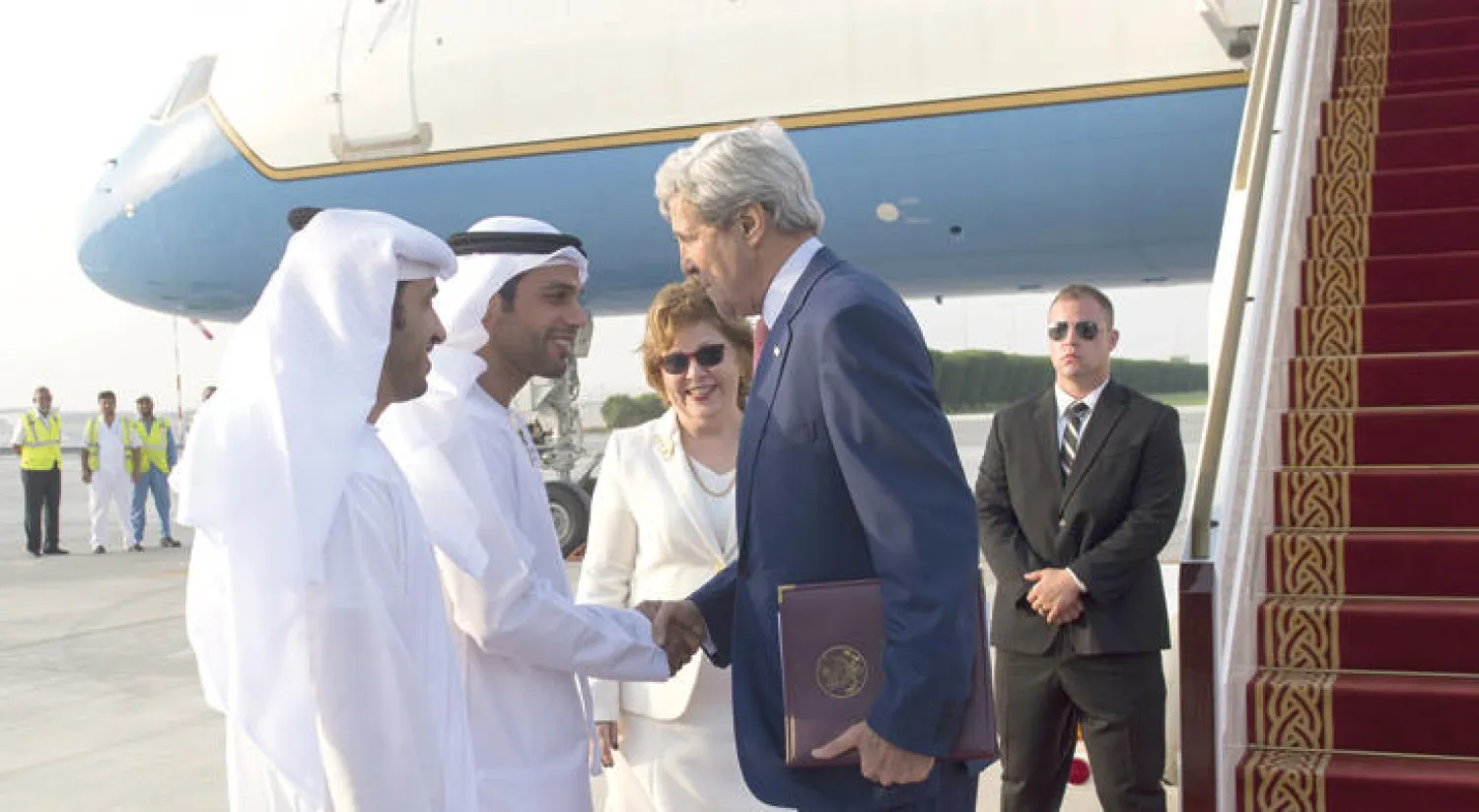 وزير الخارجية الأميركي جون كيري لدى وصوله إلى مطار أبو ظبي أمس ويستقبله رئيس التشريفات الإماراتي شهاب الفهيم (أ.ف.ب)