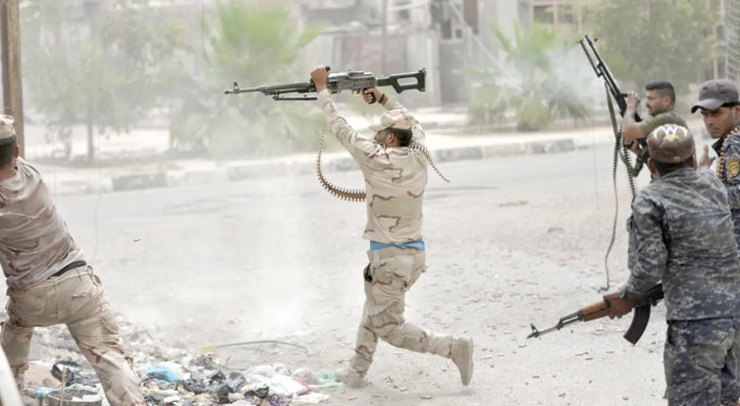 جنود عراقيون يطلقون نيران بنادقهم أمس ابتهاجاً باستعادة الفلوجة من تنظيم داعش (أ.ف.ب)