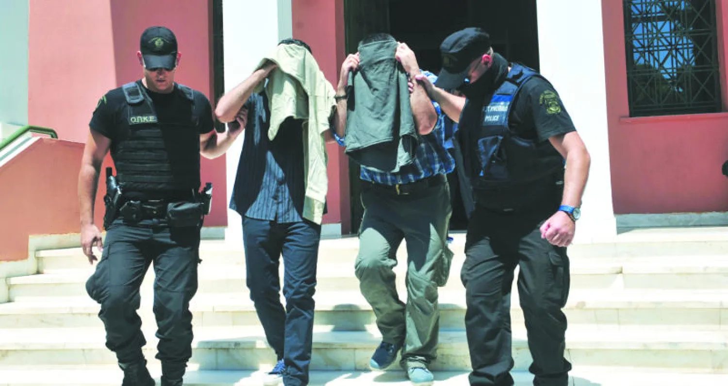 جنديان تركيان بعد مثولهما أمام محكمة «أليكساندرو بولي» اليونانية أمس ضمن النظر في قضية العسكريين الأتراك الثمانية الفارين بعد فشل الانقلاب (أ.ف.ب)