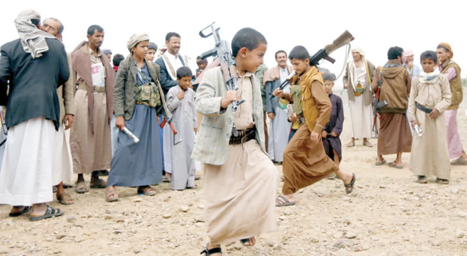 أطفال يستعرضون بالأسلحة في تجمع حوثي قرب صنعاء الأسبوع الماضي (رويترز)