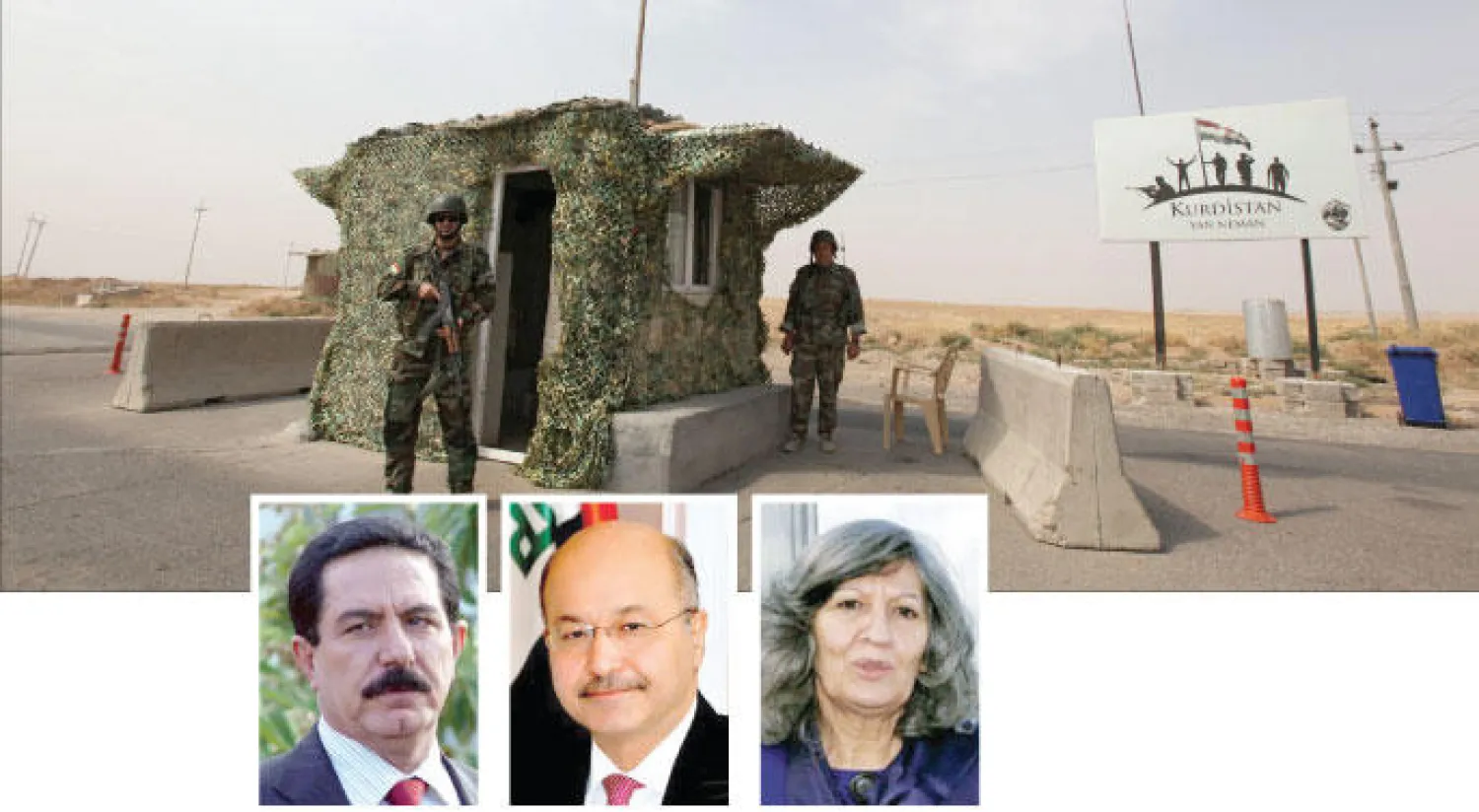 عنصران من البيشمركة في نقطة تفتيش على مدخل بلدة الكوير  في إقليم كردستان العراقي (رويترز) - هيرو ابراهيم احمد - برهم صالح - كوسرت رسول علي