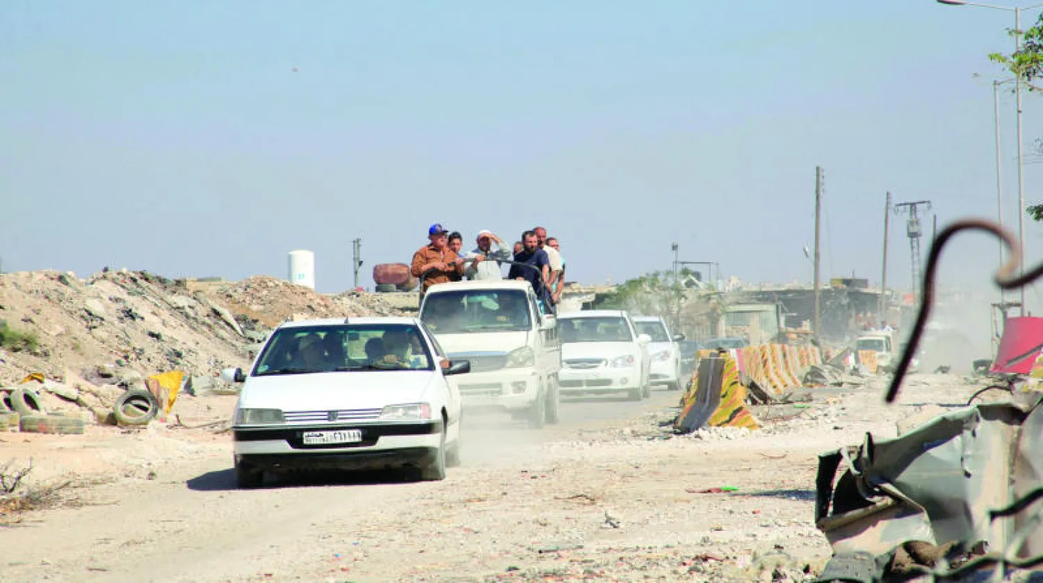 سوريون يفرون بسياراتهم من الراموسة جنوب حلب بعد تعرضها للهجوم أمس (رويترز)