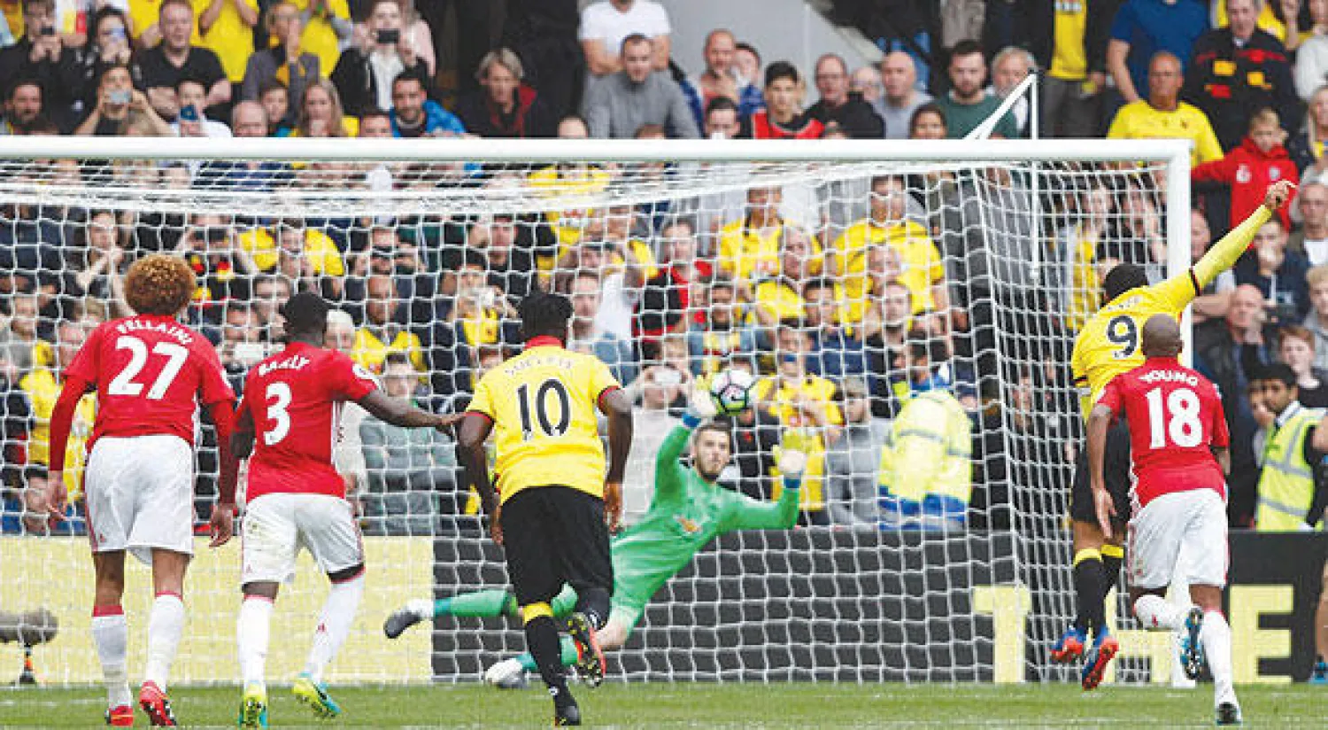 ديني (الثاني من اليمين) يسجل من ركلة الجزاء ثالث أهداف واتفورد في مرمى دي خيا حارس يونايتد (أ.ف.ب)