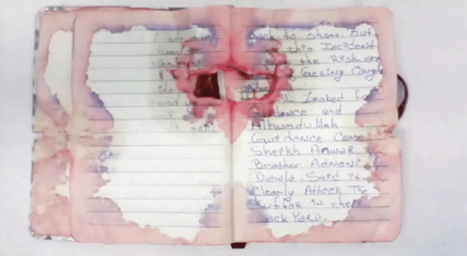 صورة لصفحة ملطخة بالدماء من يوميات المشتبه به رحمي تحمل آثار الحرق من طلقات الرصاص (واشنطن بوست)