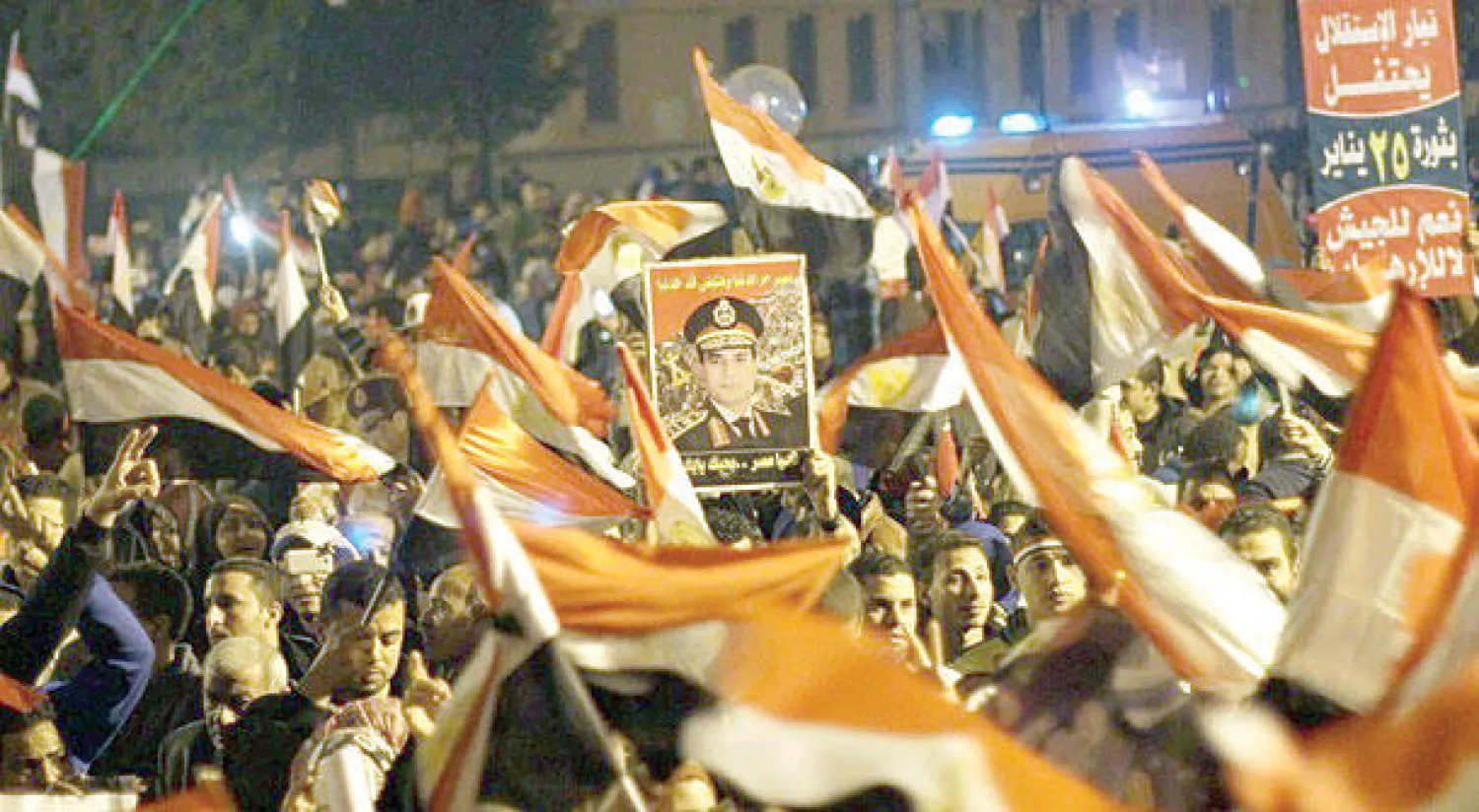 صورة أرشيفية لمصريين يرفعون أعلام بلادهم وصورة الرئيس عبد الفتاح السيسي في ميدان التحرير («واشنطن بوست»)