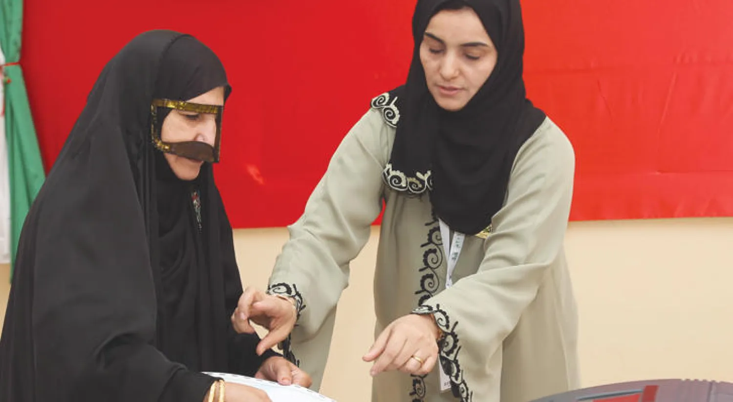 عمانية تدلي بصوتها في مركز اقتراع أمس (أ.ف.ب)