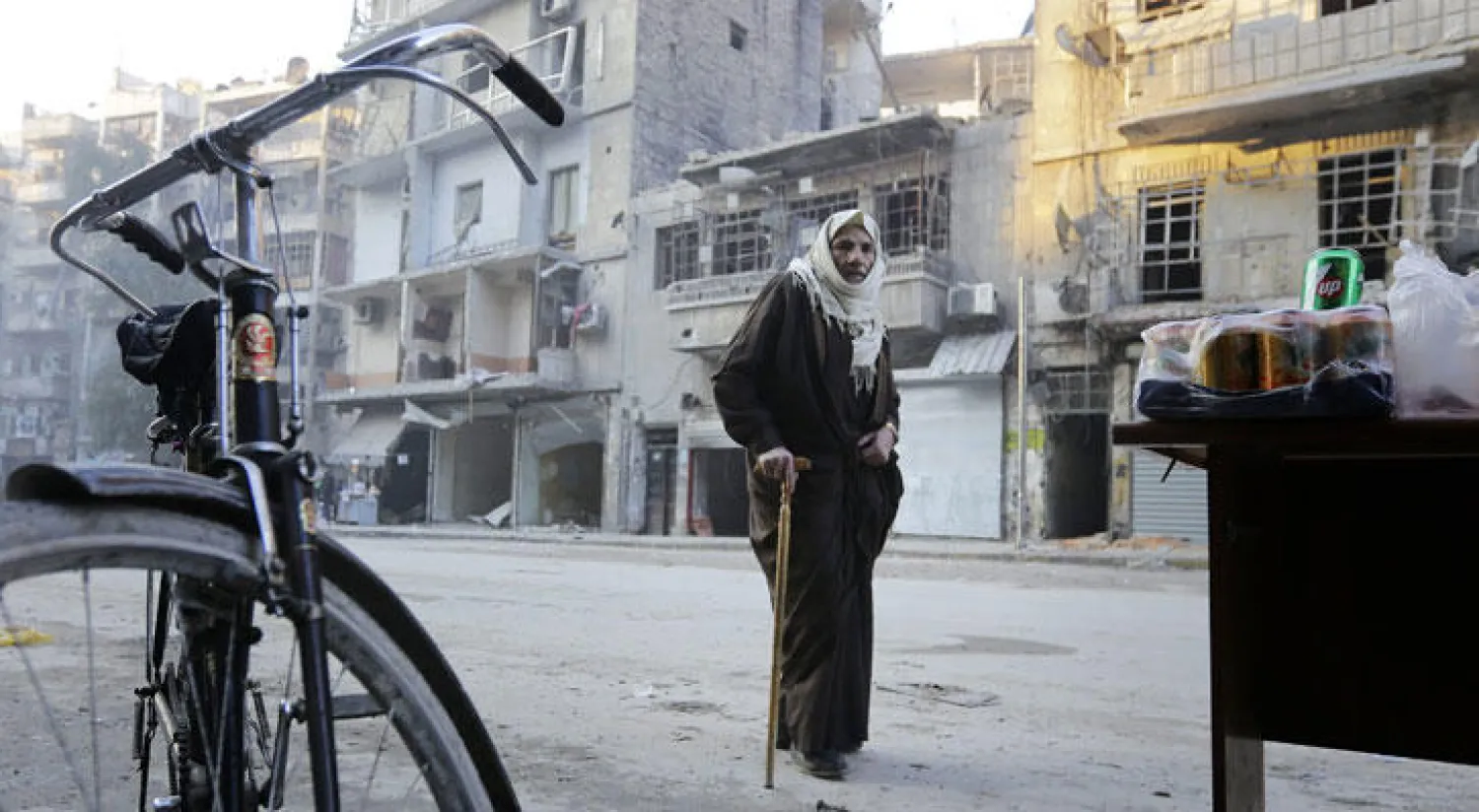 سوري يقف أمام مبان في حي الشعار المدمر بفعل الحرب في مدينة حلب أمس (أ.ف.ب)