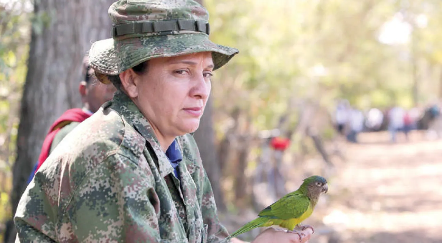 مقاتلة من حركة فارك تحمل طائرا أثناء استقبالها لجنود الجيش الكولومبي لإنهاء صراع مسلح دام أكثر من 50 عاما (إ.ب.أ)