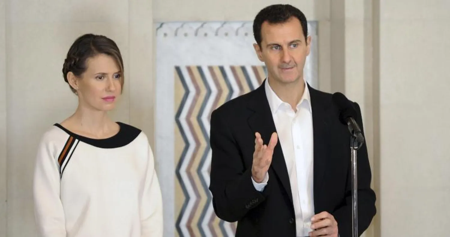 بشار الأسد وزوجته أسماء خلال الاحتفال بيوم الأم السورية في 21 مارس 2016 بدمشق (رويترز)