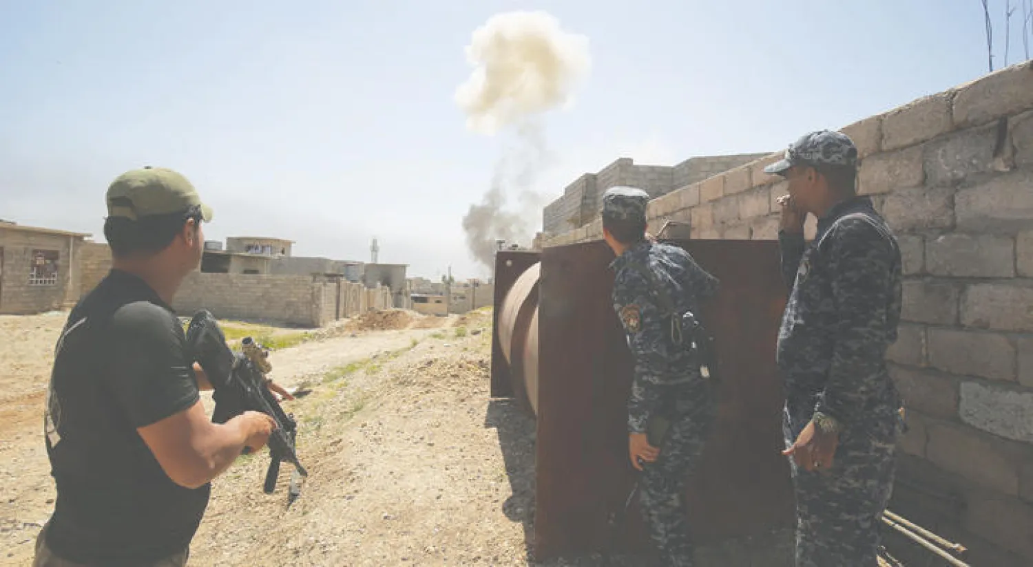 جنود عراقيون يحتمون من انفجار سيارة مفخخة لـ«داعش» في منطقة الهرمات شمال غربي الموصل أمس (أ.ف.ب)