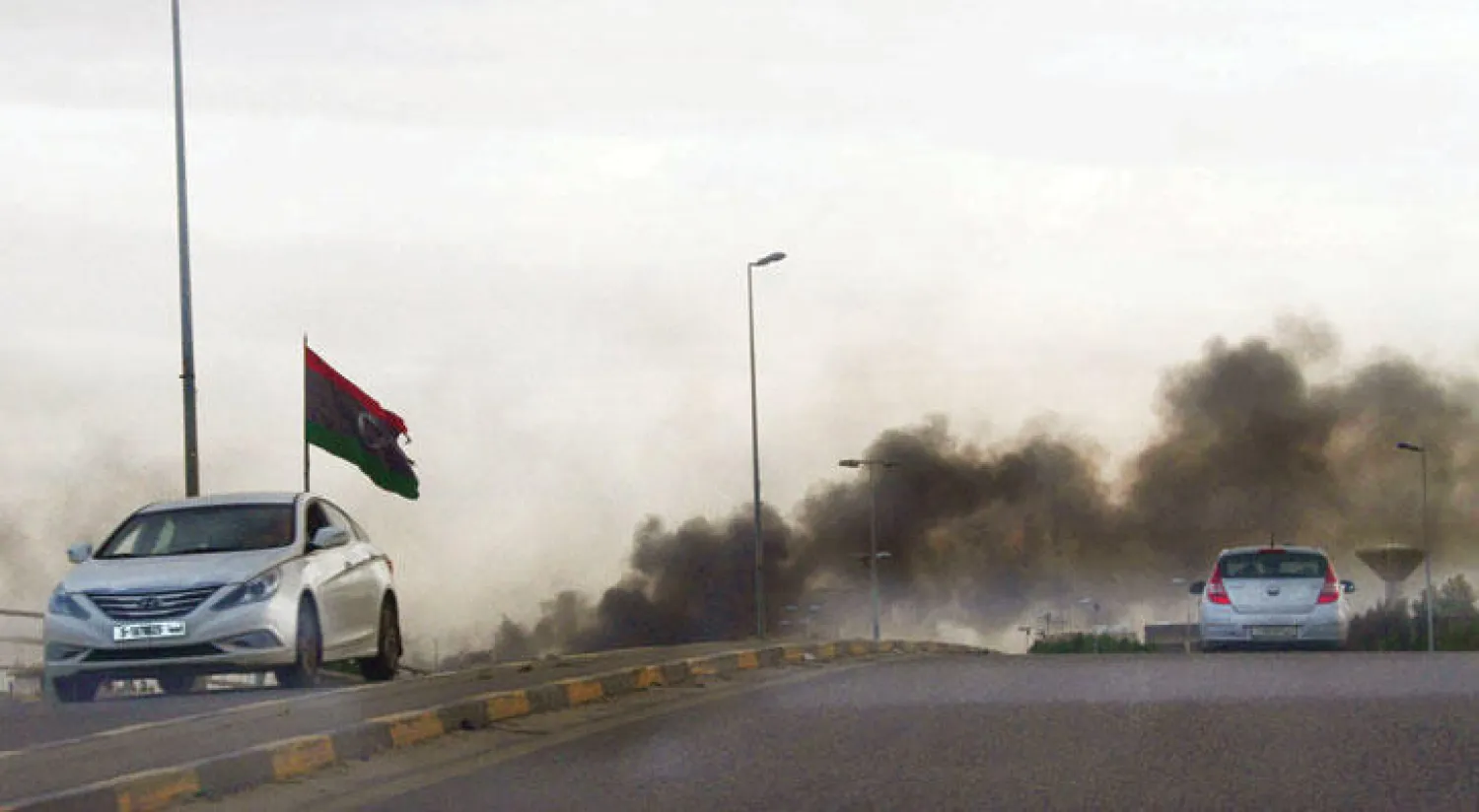 دخان يتصاعد غي أعقاب اشتباكات شهدتها طرابلس بين فصائل متطرفة أمس (رويترز)