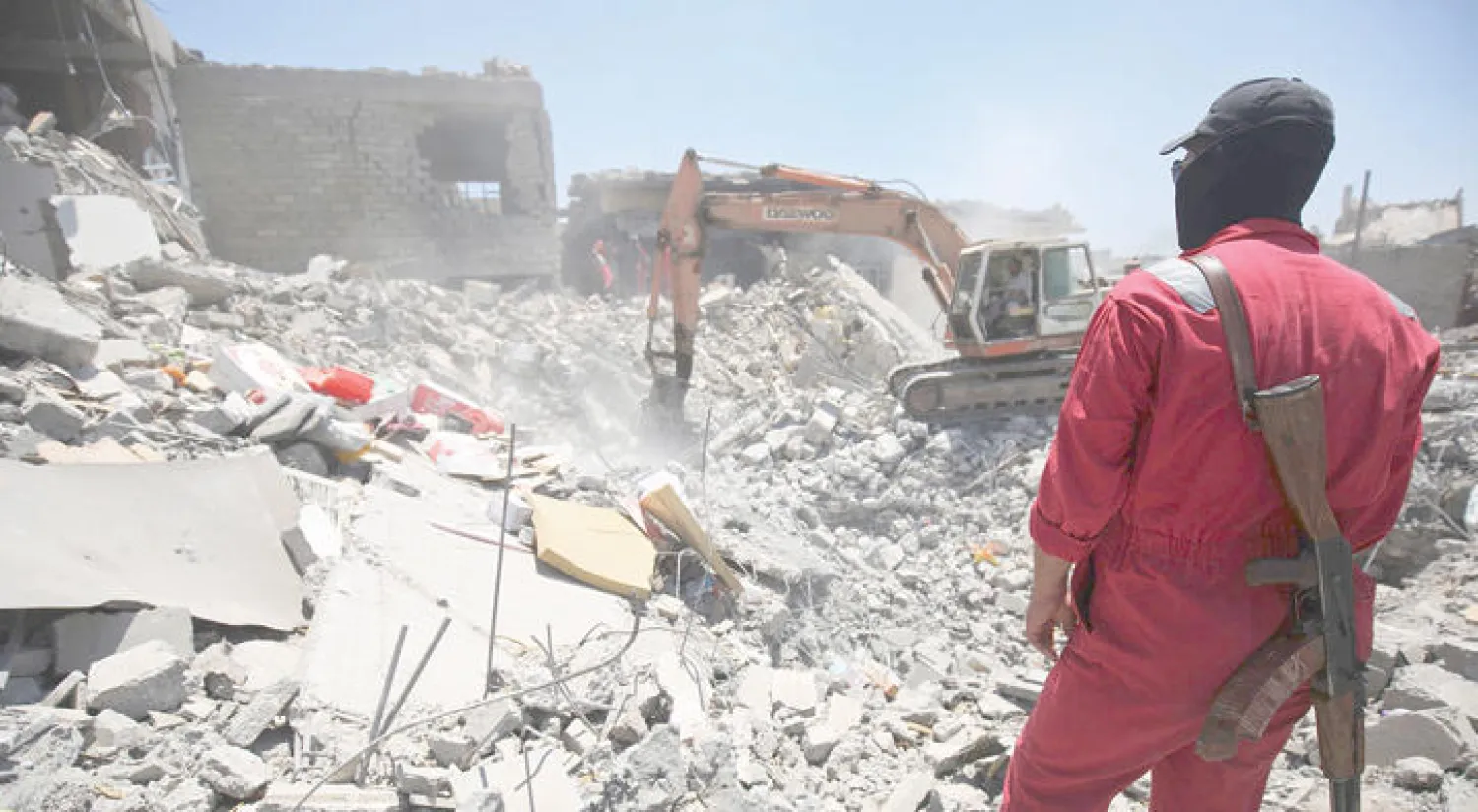 آلية للدفاع المدني تزيل ركام أحد المنازل في غرب الموصل (أ.ف.ب)