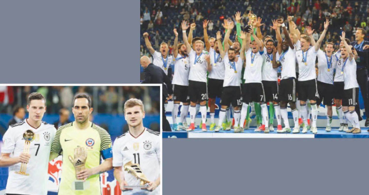 لاعبو منتخب ألمانيا يحتفلون بالتتويج أبطالاً لكأس القارات (رويترز)  -  الألماني تيم فيرنر هداف البطولة مع التشيلي برافو أفضل حارس ودراكسلر أفضل لاعب في البطولة (إ.ب.أ)