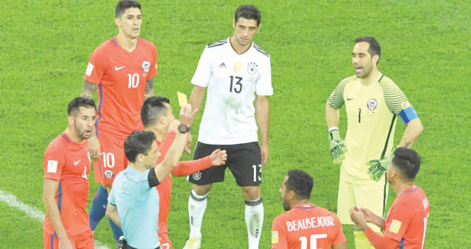 الحكم مازيتش يشهر الكارت الاصفر في وجه  التشيلي غونزالو خارا في نهائي كأس القارات بعد مشاهدة الفيديو(أ.ف.ب)