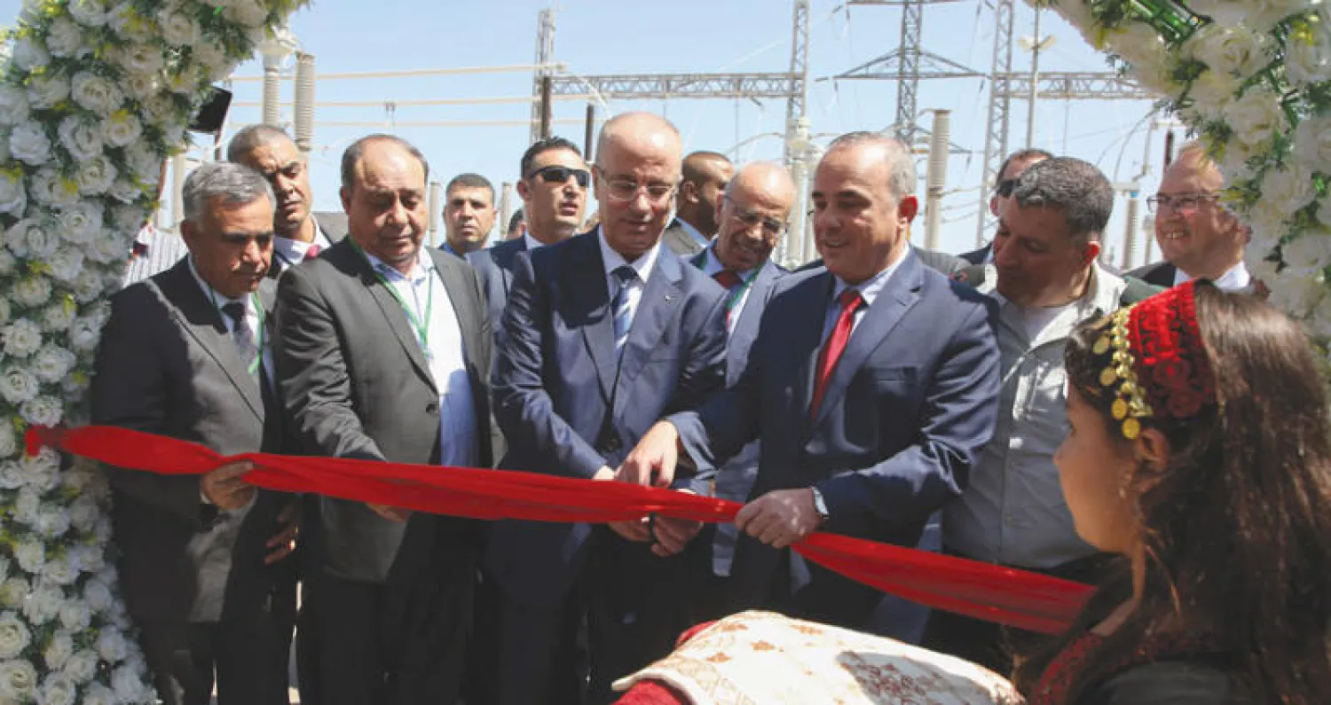 رئيس الوزراء الفلسطيني رامي الحمد الله (وسط) ووزير الطاقة الإسرائيلي يوفال شطاينتس (يمين) يدشان محطة كهرباء جديدة في الجلمة بالضفة الغربية (أ.ف.ب)