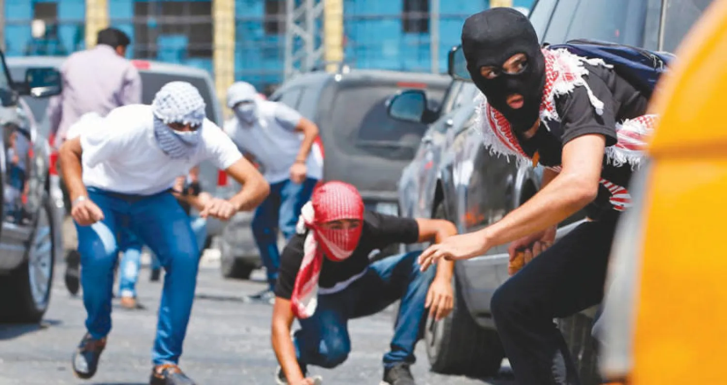 شبان فلسطينيون يشتبكون مع قوات الاحتلال الإسرائيلي بالحجارة عند مستوطنة بيت إيل القريبة من رام الله (أ.ف.ب)
