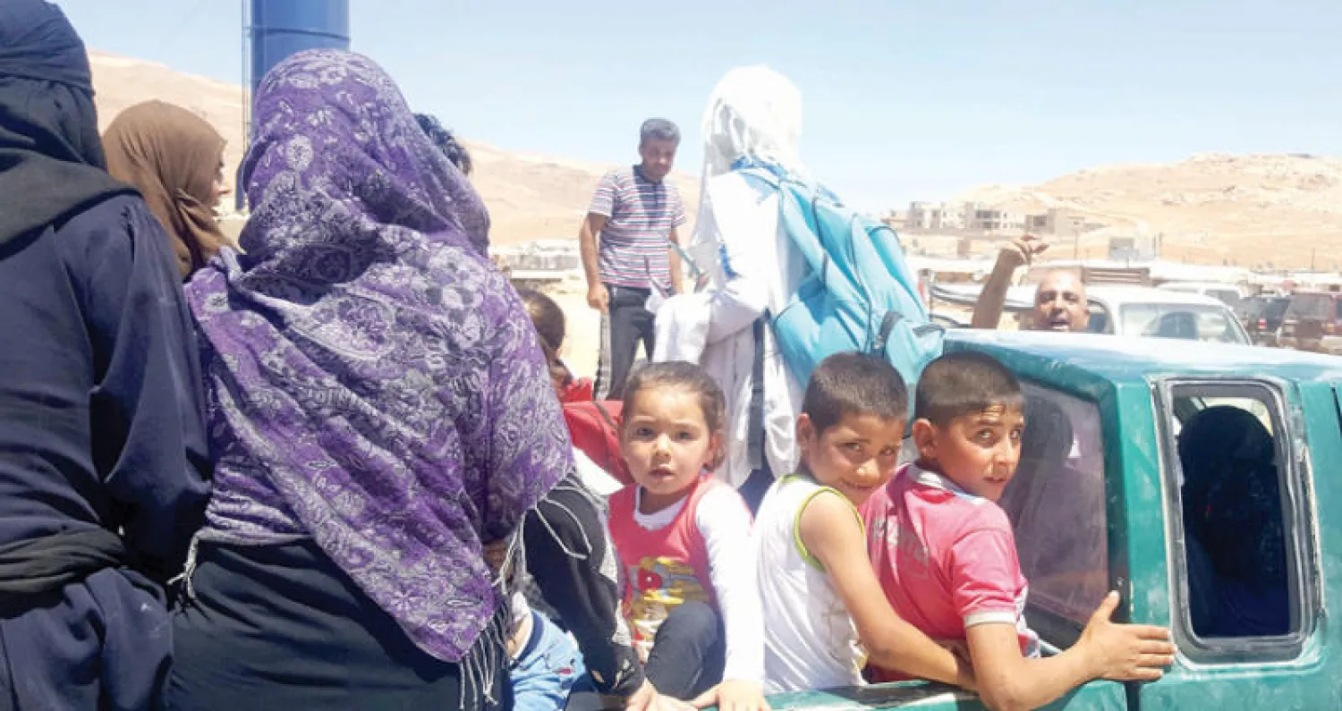 لاجئون سوريون في وادي حميد قرب عرسال اللبنانية قبل انتقالهم إلى إدلب في شمال سوريا أمس (أ.ف.ب)