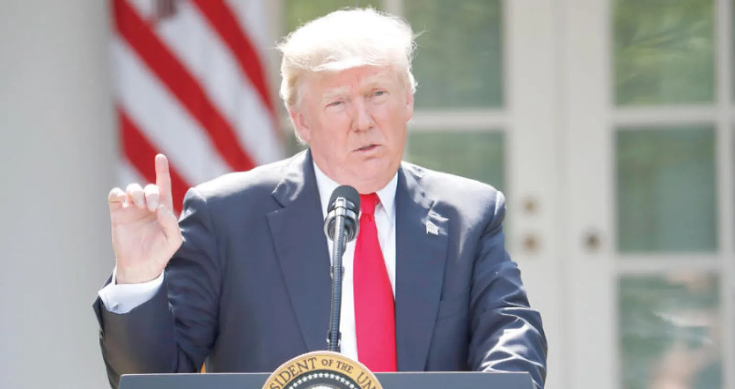 الرئيس الأميركي يتكلم حول اتفاقية باريس للمناخ في حديقة البيت الأبيض (أ.ب)