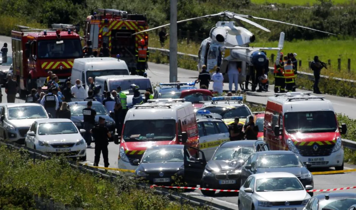 Police and rescue forces are seen on the scene where the man suspected of ramming a car into a group of soldiers on Wednesday in the Paris suburb of Levallois-Perret was shot and arrested on the A16 motorway, near Marquise, France, August 9, 2017.  REUTERS/Pascal Rossignol