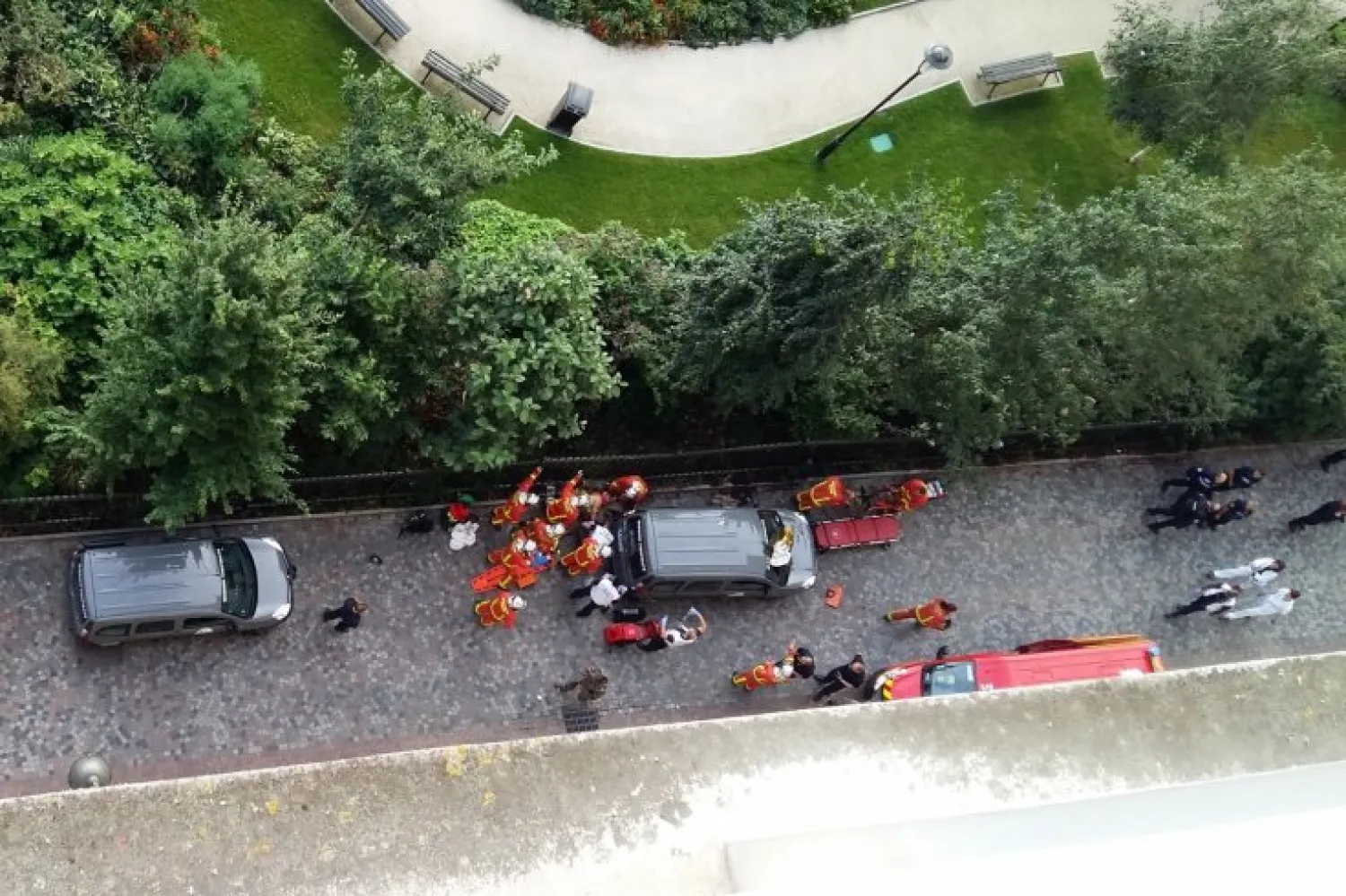 Officials and rescuers gather near vehicles after a car slammed into soldiers on patrol in Levallois-Perret, outside Paris on August 9, 2017. (AFP)